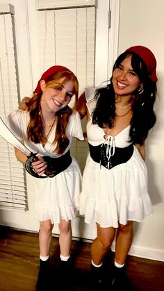 two girls dressed in pirate costumes posing for the camera