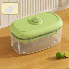 a plastic container with limes on the table