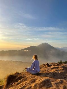 a person sitting on top of a hill