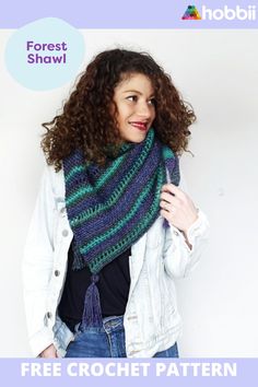 a woman with curly hair wearing a blue, green and purple striped knitted scarf