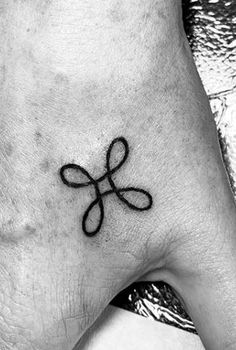 a black and white photo of a person's foot with a tattoo on it