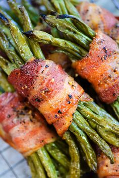 bacon wrapped green beans on a plate with the words green bean bacon bundles above it