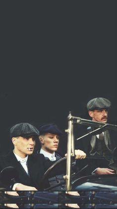 three men sitting in an old fashioned car