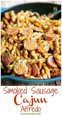 smoked sausage and cajun alfredo pasta in a blue bowl with text overlay that reads smoked sausage and cajun alfredo