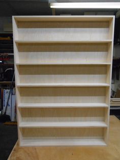 a wooden book shelf sitting on top of a table in a room with other items