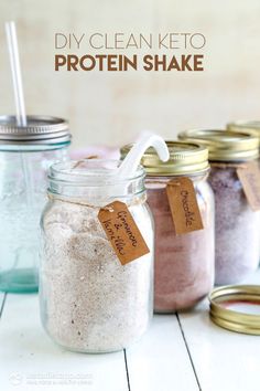 three jars filled with different types of protein shakers and one has a straw in it