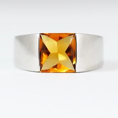 This stunning 14K solid white gold ring features a 1.6 carat canary yellow natural citrine stone in a chic Cartier style setting. The square-shaped citrine adds a pop of vibrant colour to the simple yet elegant design, making it a perfect ring for any special occasion. Crafted with high-quality materials, this fine jewellery piece is a luxurious addition to any collection. With a classic yet modern design, this piece is ideal for those who appreciate fine craftsmanship and unique gemstones. Perf Modern Citrine Rings For Formal Occasions, Polished Yellow Topaz Ring, Modern Yellow Rings For Anniversary, Modern Gold Topaz Ring, Modern White Gold Citrine Jewelry, Modern White Gold Jewelry With Citrine, Modern Citrine Rings For Anniversary, Modern Formal Hallmarked Topaz Ring, Modern Yellow Gold Topaz Ring With Rectangular Shape