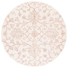 a round rug with an intricate design on the top and bottom, in white and pink