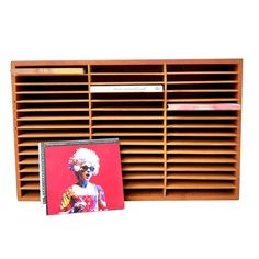 a wooden shelf with cd's on it and a card case next to it