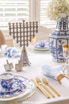 the table is set with blue and white china