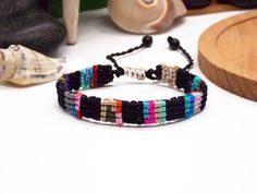 A stylish and eco-friendly Cord Bracelet, featuring a vibrant black design adorned with colorful squares. Crafted from durable cords, this waterproof accessory not only adds flair to your outfit but also contributes to environmental conservation by repurposing discarded materials. It's adjustable and fits most wrists!  ◼️ WHY DO YOU NEED THIS? This one-of-a-kind macrame bracelet is not just an accessory, it's a wearable work of art. Crafted using recycled threads, this bracelet features vibrant Surfer Bracelets, Environmental Conservation, Eco Friendly Jewelry, Macrame Bracelet, Cord Bracelet, Macrame Bracelets, Cord Bracelets, Rag Rug, Patchwork Designs