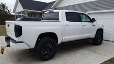 a white truck parked in front of a house