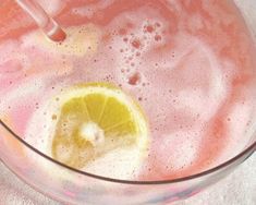 a glass filled with liquid and a lemon slice