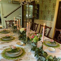 the table is set with plates and place settings