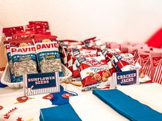 a table topped with bags of crackers and other snacks on top of each other