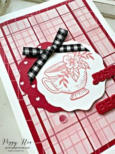 a close up of a card with a stamp on it and a bow at the top