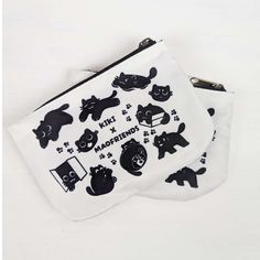 two zippered pouches with black cats on them