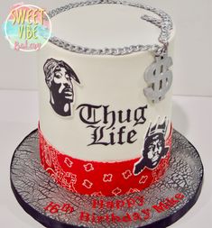 a white and red birthday cake with chains on the top that says, thug life