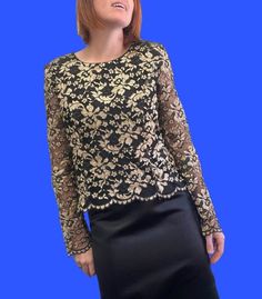 Designer 90s does medieval style black and gold lace blouse. Think grungy Drew Barrymore or even Courtney Love. Round neck with button down back and long, sheer lace sleeves with scalloped cuffs. The hemline is also scalloped. Well made with beautiful quality fabric and just the right amount of edginess. Great vintage condition with minimal signs of wear. Brand is Geoff Bade made in Australia. Sized 14 but would best fit up to size 12 modern Australian women's sizing. MEASUREMENTS (AS PER LABEL) Gothic Long Sleeve Blouse For Evening, Fall Party Tops With Lace Work, Gothic Lace Trim Top For Party, Gothic Lace Trim Party Top, Gothic Lace Top With Lace Trim For Party, Gothic Party Lace Top With Lace Trim, Black Lace Top For Party With Lace Work, Gothic Party Tops With Lace Sleeves, Gothic Lace Tops For Party