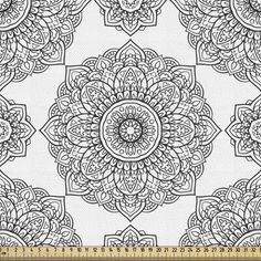 a white and black floral pattern on fabric with a ruler in front of the image