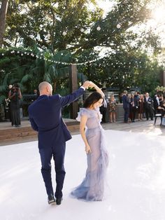 a man and woman dancing in front of an audience