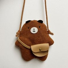 a brown bear purse hanging on a wall