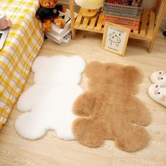 a teddy bear rug is on the floor next to a bed with yellow and white sheets