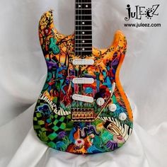 an electric guitar with colorful designs on it