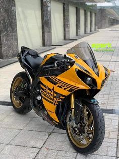 a yellow and black motorcycle parked on the street