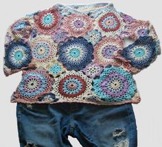 a crocheted sweater and shorts are shown with torn jeans on the bottom floor