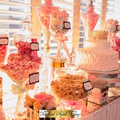 an assortment of candy and candies on display in a window sill at a wedding