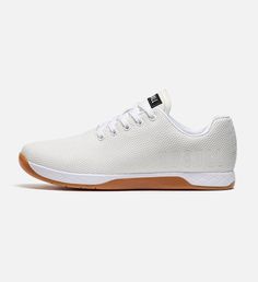 a white tennis shoe with brown soles