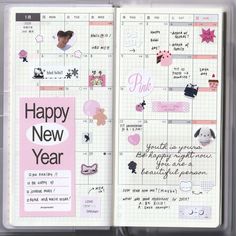 an open planner book with stickers and writing on the pages that says happy new year