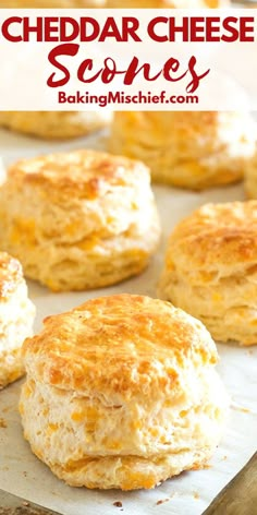 cheddar cheese scones on a baking sheet with text overlay that reads cheddar cheese scones