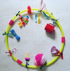 a circle made out of plastic toys on a white surface with other items around it