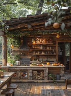 an outdoor kitchen with lots of wood and greenery on the roof, surrounded by trees