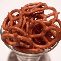 a glass bowl filled with pretzels on top of a table