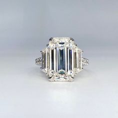 an emerald cut diamond ring with side stones