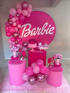 pink and silver balloons are on display in front of a sign that says, barbie