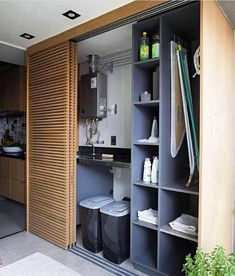 an open closet with two bins and several items on the shelves next to it