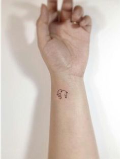 a small elephant tattoo on the wrist