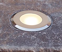 a close up of a light on a stone surface