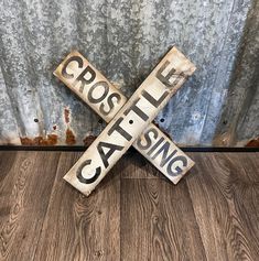 two wooden signs that say cross life and sing the same song on wood flooring