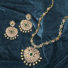 Description: This marvelous CZ necklace set by Tarinika is as timeless as it is radiant. Both necklace and earrings display a beautiful arrangement of high-quality CZ stones, glittering brilliantly in the form of florals. Perfect to accentuate wedding outfits with an elegant touch, this necklace set can be combined with matching pieces of Tarinika CZ jewelry for a grand loyal look. Details & Specifications: Materials used: CZ Stone with Yellow Gold Plating Weight - Necklace 66.5 gms, Earrings 34 Dazzling Necklace With Elegant Design For Festive Season, Elegant Chandbali Necklaces For Eid, Eid Chandbali Elegant Necklaces, Festive Celebration Necklace In Cubic Zirconia, Festive Dazzling Bridal Necklace With Elegant Design, Festive Cubic Zirconia Jewelry Sets With Elegant Design, Dazzling Necklaces For Festive Celebrations, Festive Cubic Zirconia Necklaces For Weddings, Festive Celebration Cubic Zirconia Necklaces