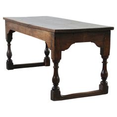 an old wooden table with two legs and a small shelf on the top that is attached to it