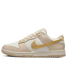 The Nike Dunk Low 'Gold Swoosh' is a stylish and perfect sneaker for women. It features a full leather upper with a mesh tongue and lining. The white base is accented with a golden Swoosh and a brown-tan overlay for a subtle branding. The two-tone rubber outsole completes the design. This sneaker is perfect for a variety of activities, from running to casual wear. The inspiration behind the design is to create a sneaker that is both stylish and comfortable. The Nike Dunk Low 'Gold Swoosh' is the perfect addition to any wardrobe. (SNKR/Skate/Low Top/Women's/Non-Slip/Wear-resistant) Perfect Sneakers, Nike Dunk Low, Dunk Low, Nike Dunks, Nike Women, Two Tone, Casual Wear, Leather Upper, Two By Two