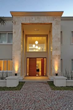 an entrance to a building with lights on it