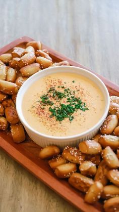 a plate with some food on it and a bowl filled with sauce in the middle