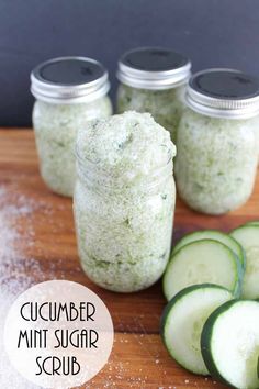 cucumber mint sugar scrub in mason jars on a cutting board with sliced cucumbers