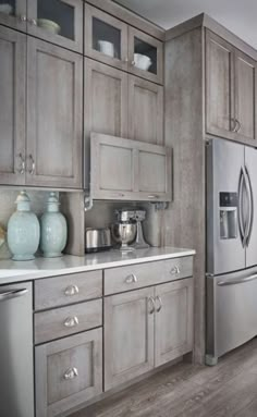 a kitchen with wooden cabinets and stainless steel appliances